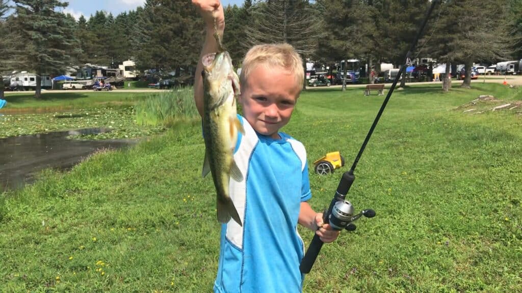 Fishing Kid Holding Up Fish