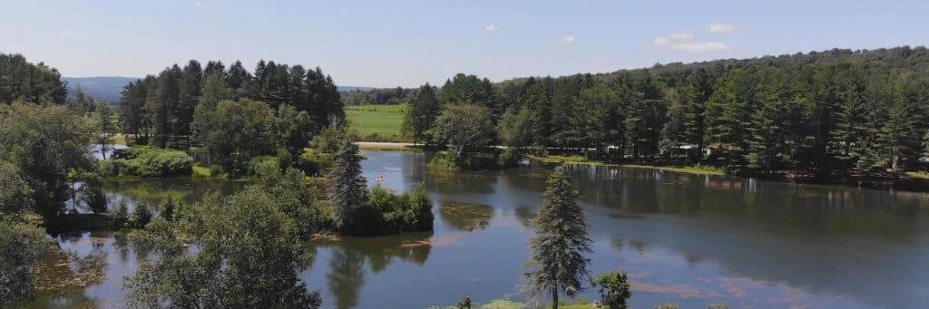 Aerial view of Rainbow Lake and its wooded peninsulas